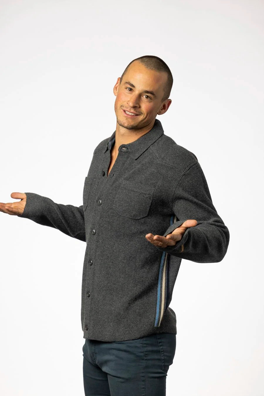 Man wearing a gray button-up shirt on a white background