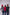 Three people standing together wearing colorful clothing against a white background