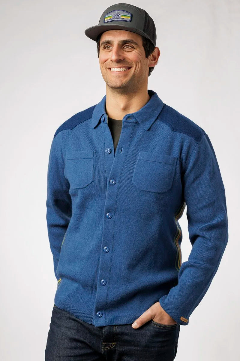 Man wearing a blue shirt and cap on a white background