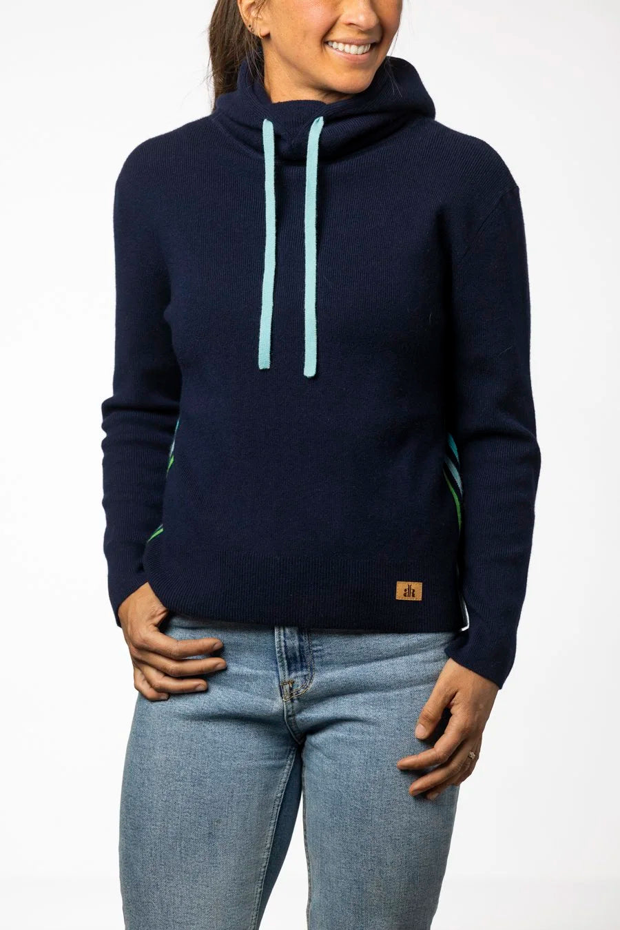 Person wearing a navy blue hoodie with light blue drawstrings on a white background