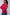 Woman wearing a pink sweater with colorful stripes on the sleeves against a white background