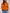 Person wearing an orange sweater with colorful stripes on a plain background